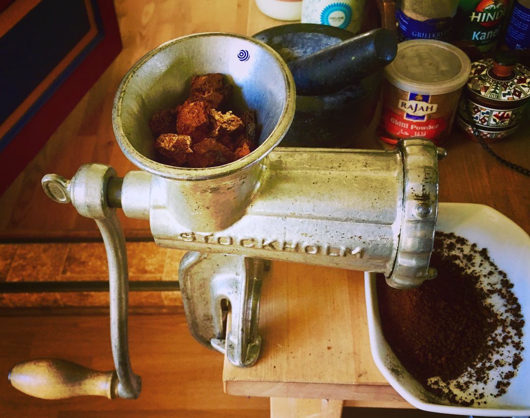 Photo of grinding chaga with an old meat grinder